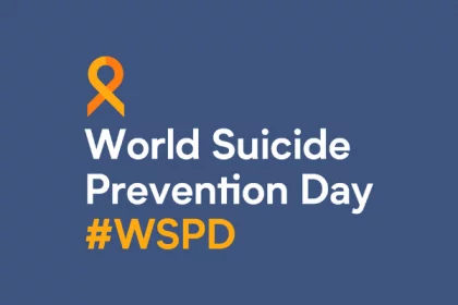 A blue background with white text and orange ribbon. The world suicide prevention day logo
